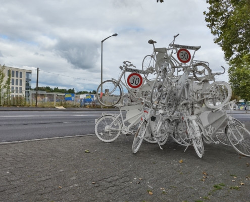 Fahrradskulpur mit Geisterfahrrädern und Tempo 30 ist gesünder Schildern